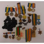 A quantity of WWI and WWII medals, badges and coat buttons