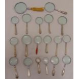 Nineteen magnifying glasses with hallmarked silver handles of various shape and form
