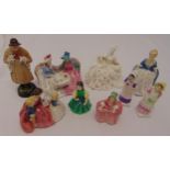 Nine Royal Doulton figurines to include ladies at tea and a shepherd holding two lambs