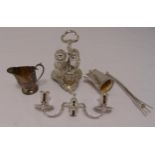 A hallmarked silver condiment set, the trefoil stand with pierced central scroll handle on leaf feet