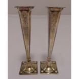 A pair of hallmarked silver vases, tapering rectangular engraved with flowers and leaves on raised