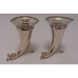 A pair of Goldsmiths and Silversmiths Company silver vases of horn shape with scroll pierced tops