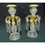 A pair of gilt metal and cut glass single light girandoles with faceted drop pendants on fluted