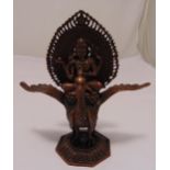 Tibetan bronze Buddha seated on a peacock mounted on a raised octagonal base, 27.5 x 21cm