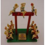 An Art Deco style miniature display with composition figurines of female swimmers posing on an