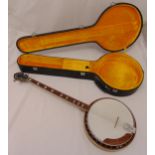 A Conqueror four string tenor banjo with inlaid mother of pearl frets in fitted banjo case