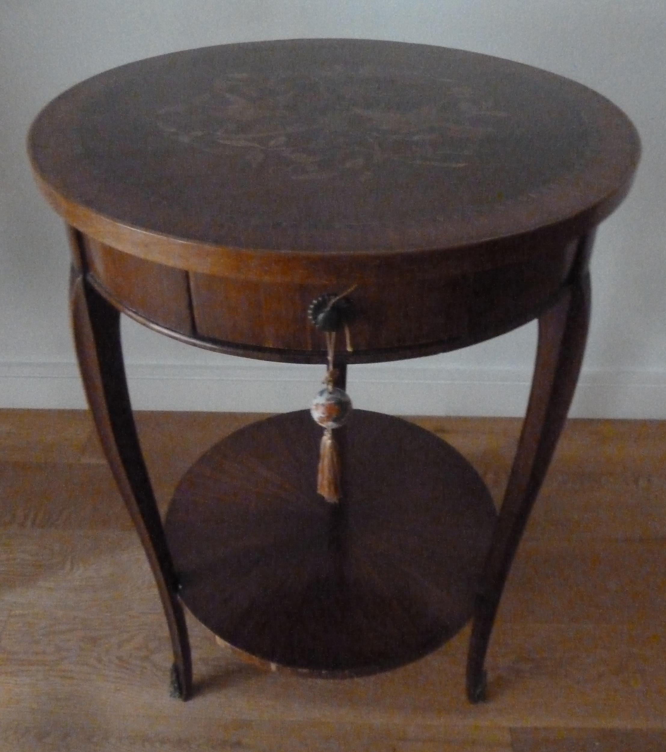 An early 20th century mahogany circular two tier occasional table, with single drawer, the top