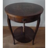 An early 20th century mahogany circular two tier occasional table, with single drawer, the top