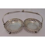 A hallmarked silver nut dish in the form of two pierced circular bowls with wirework handle, on four