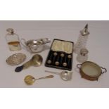 A quantity of hallmarked silver comprising an oval sauceboat, a spirits flask, an inkwell, a sugar