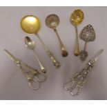 Two Victorian hallmarked silver sifter spoons, a pair of vine chased grape shears, another pair of