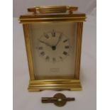 Sewells of Liverpool gilded metal carriage clock of customary form, white enamel dial and Roman