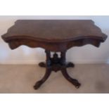A Victorian shaped rectangular mahogany and walnut card table, on four scroll supports, 93 x 49 x
