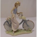 Lladro figurine of a girl on a bicycle, marks to the base, 25 x 25cm