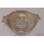 A hallmarked silver nut dish, circular, bar pierced sides with pierced side handles, Birmingham