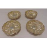 Four Victorian hallmarked silver bonbon dishes, shaped circular, pierced sides on three ball feet,