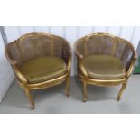 A pair of French style gilded wood and bergere armchairs with removable upholstered seats on four