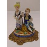 A French porcelain figural group of musicians on raised circular base with Sevres mark to the