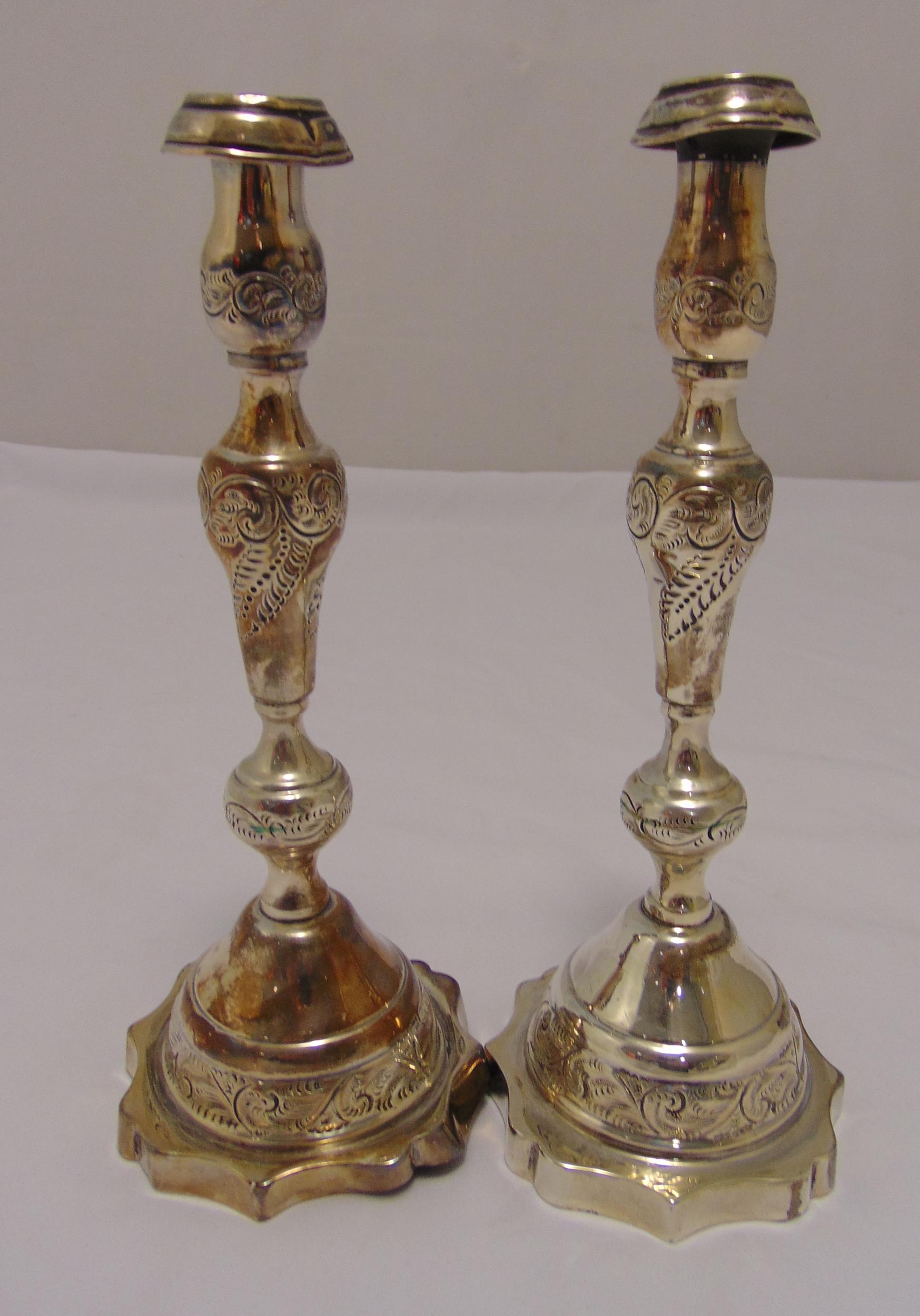 A pair of hallmarked silver table candlesticks, knopped baluster form engraved with leaves and