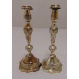 A pair of hallmarked silver table candlesticks, knopped baluster form engraved with leaves and