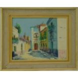 A framed oil on canvas of a Spanish courtyard, indistinctly signed bottom right, 34 x 44cm