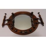 A Victorian mahogany wall mounted spindle mirror of circular form, 31 x 37cm