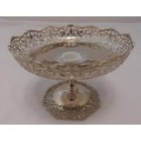 A hallmarked silver cake stand, circular with scroll and leaf pierced border on tapering stem and
