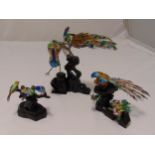 Three oriental figural groups of cloisonné birds on carved hardwood stands