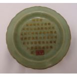 A Song style Celadon dish with raised sides and gilded Chinese characters, 19cm