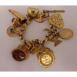 Yellow gold charm bracelet, tested 9ct with ten individual gold charms and four gold plated