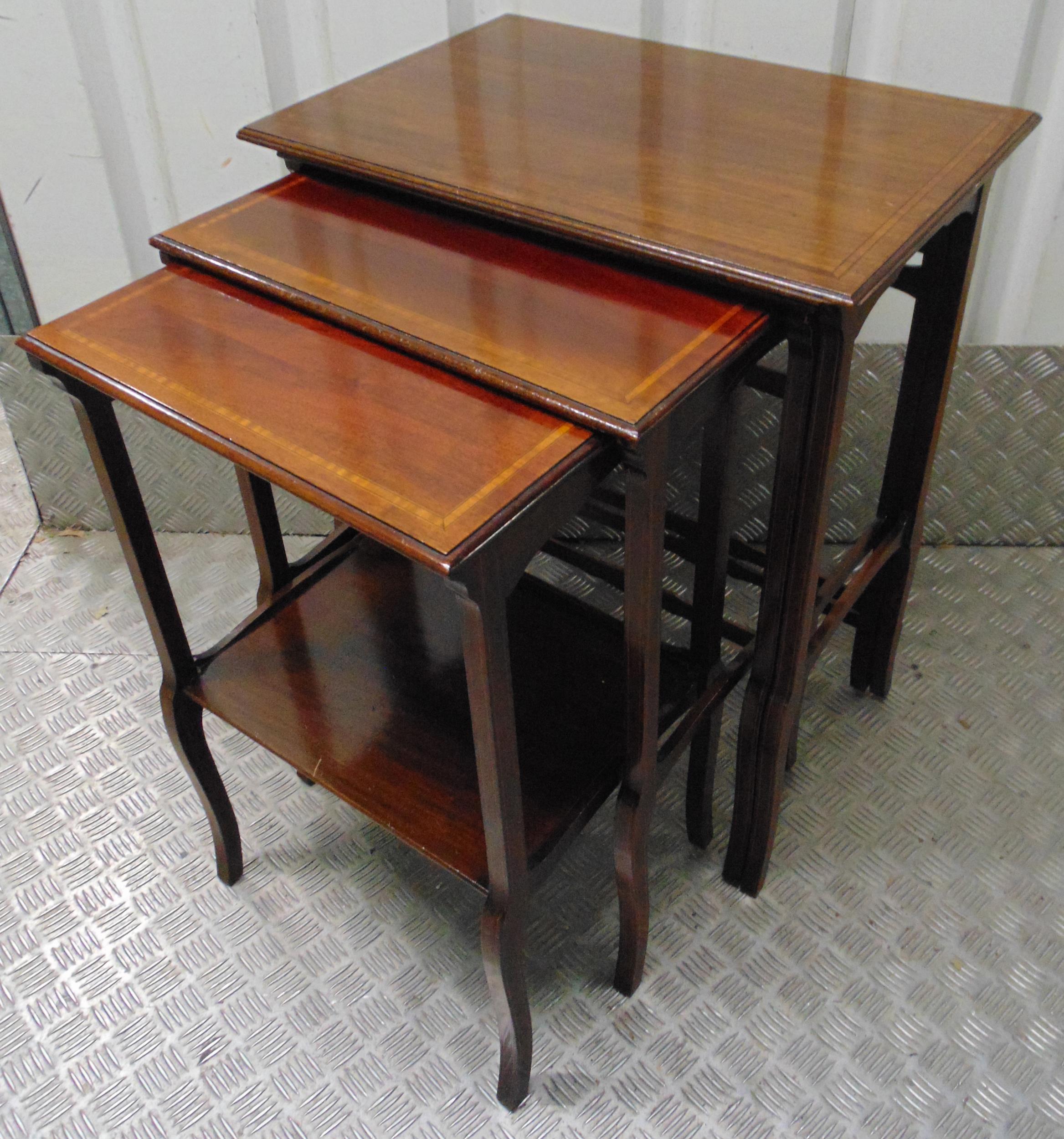 A nest of four mahogany tables with satinwood banding on tapering rectangular legs, 69 x 55 x 37.cm