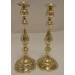A pair of hallmarked silver table candlesticks, knopped baluster form chased with flowers and leaves