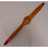 An early 20th century wooden propeller with red painted tips and serial number 0441, 112cm (w)