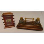An early 20th century rectangular oak inkstand, the two detachable glass inkwells with hinged