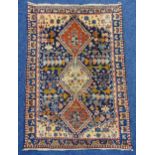 A Middle Eastern wool carpet blue ground with repeating pattern and border, 150 x 105cm