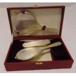 A Garrard hallmarked silver dressing table set with husk borders to include a hand mirror, a hair