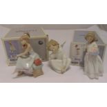 Three Lladro figurines to include putti, a little girl with flowers and a little girl with dog,