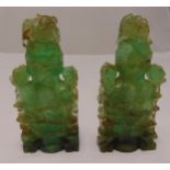 A pair of oriental carved green quartz containers with floral pull off covers on shaped