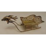 An Edwardian hallmarked silver pierced bonbon dish in the form of a reindeer pulling a sleigh,