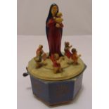 A German painted wooden musical carousel of octagonal form surmounted by Mary holding the baby