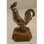 A white metal figurine of a cockerel mounted on a polished stone base, 16cm (h)