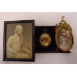 A 19th century miniature of a seated gentleman, a framed miniature of a lady and an oval miniature