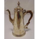 A George II hallmarked silver coffee pot, tapering cylindrical with leaf mounted spout and double