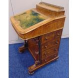 A walnut Davenport of customary form with pierced brass gallery and leather tooled hinged top,