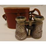 A pair of Victorian hallmarked silver mounted opera glasses, chased with scrolls and flowers,