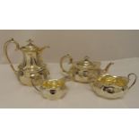 A hallmarked silver four piece tea and coffee set, shaped oval with ribbed sides and scroll handles,