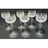 A set of six clear cut glass hock glasses with faceted stems on circular spreading bases