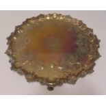 A George II hallmarked silver salver, circular shell leaf and scroll border, flat chased with birds,