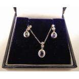 18ct white gold suite of jewellery to include pendant on chain and matching earrings set with