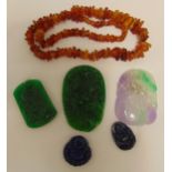 A quantity of oriental collectables to include jadeite pendants, lapis lazuli pendants and an